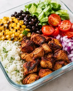 Chipotle chicken meal prep bowl with bone broth rice, charred corn, black beans, tomatoes and romaine