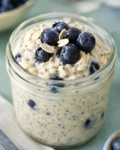 Jar of easy overnight oats topped with fresh blueberries