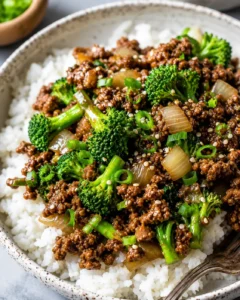 Bowl of ground beef and broccoli stir fry served over rice