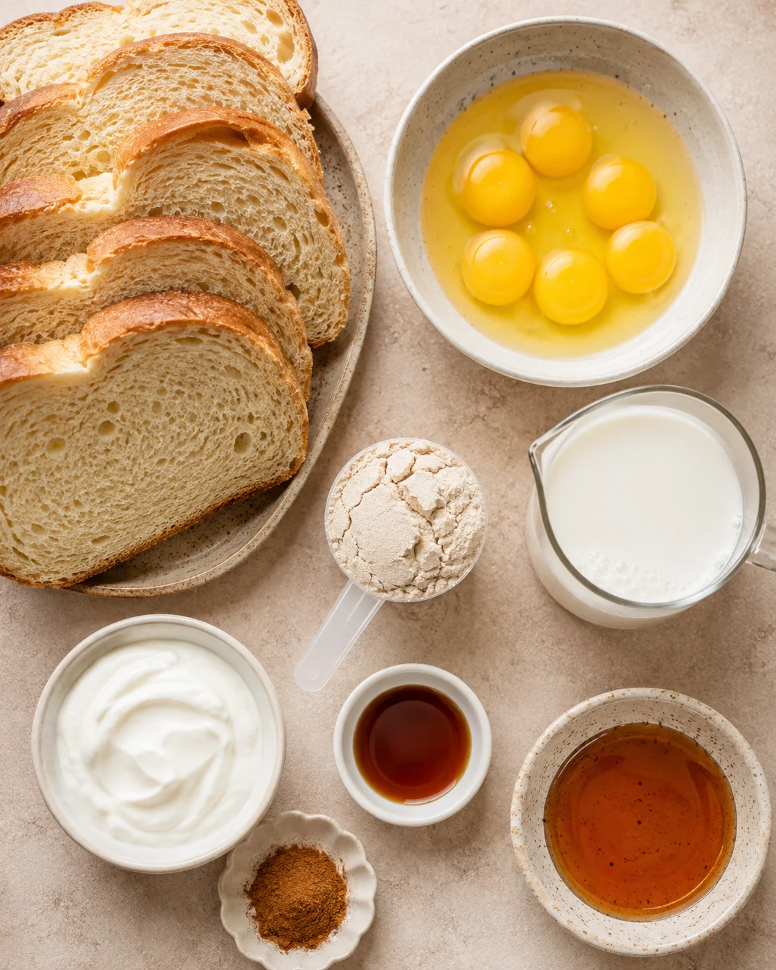 Top-down view of sliced bread, eggs, milk, protein powder and other ingredients for high protein French toast