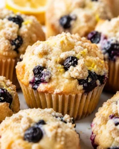 Close-up of a lemon blueberry muffin with streusel topping and visible blueberries