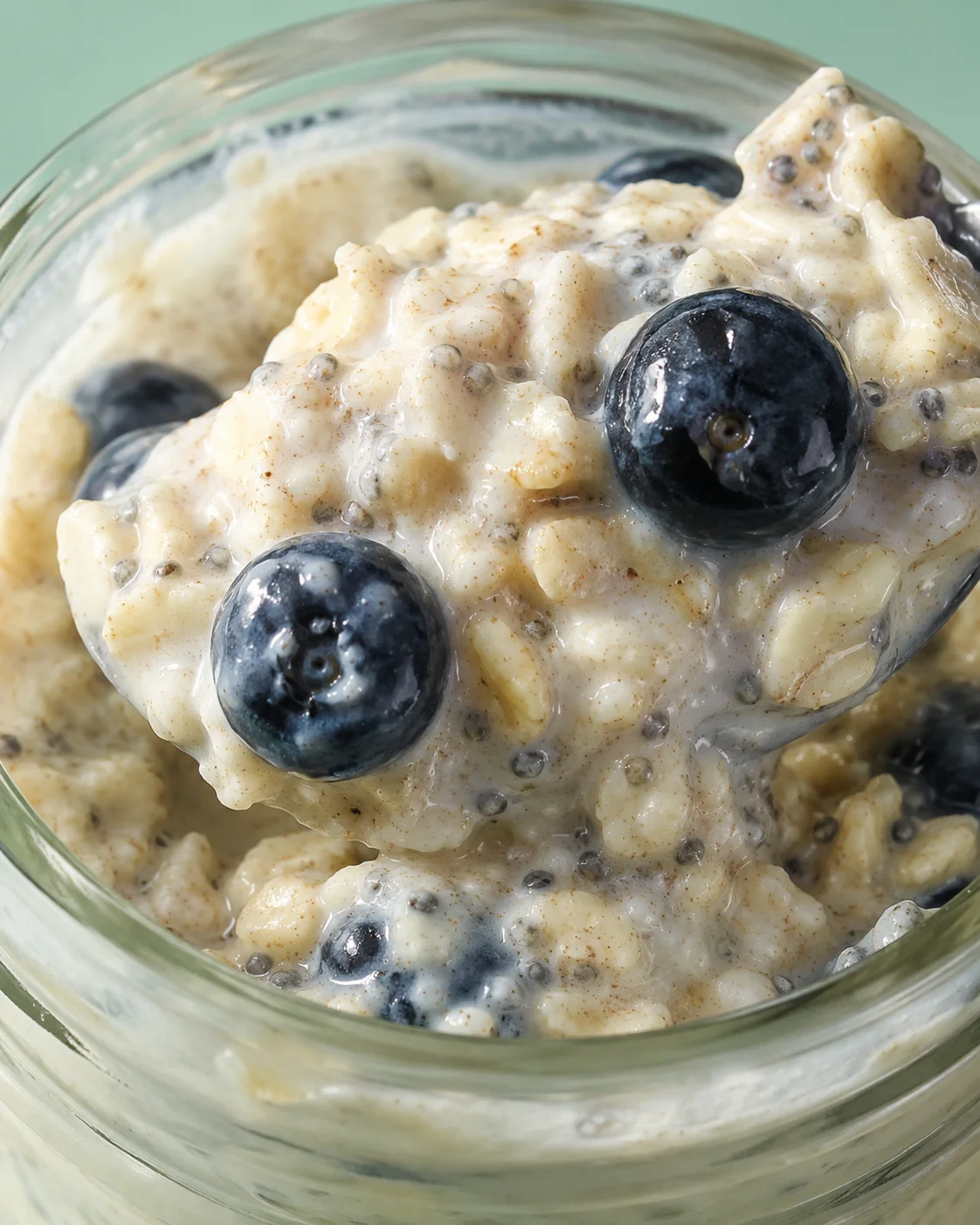 Close-up detail of overnight oats showing oats, chia seeds and blueberries