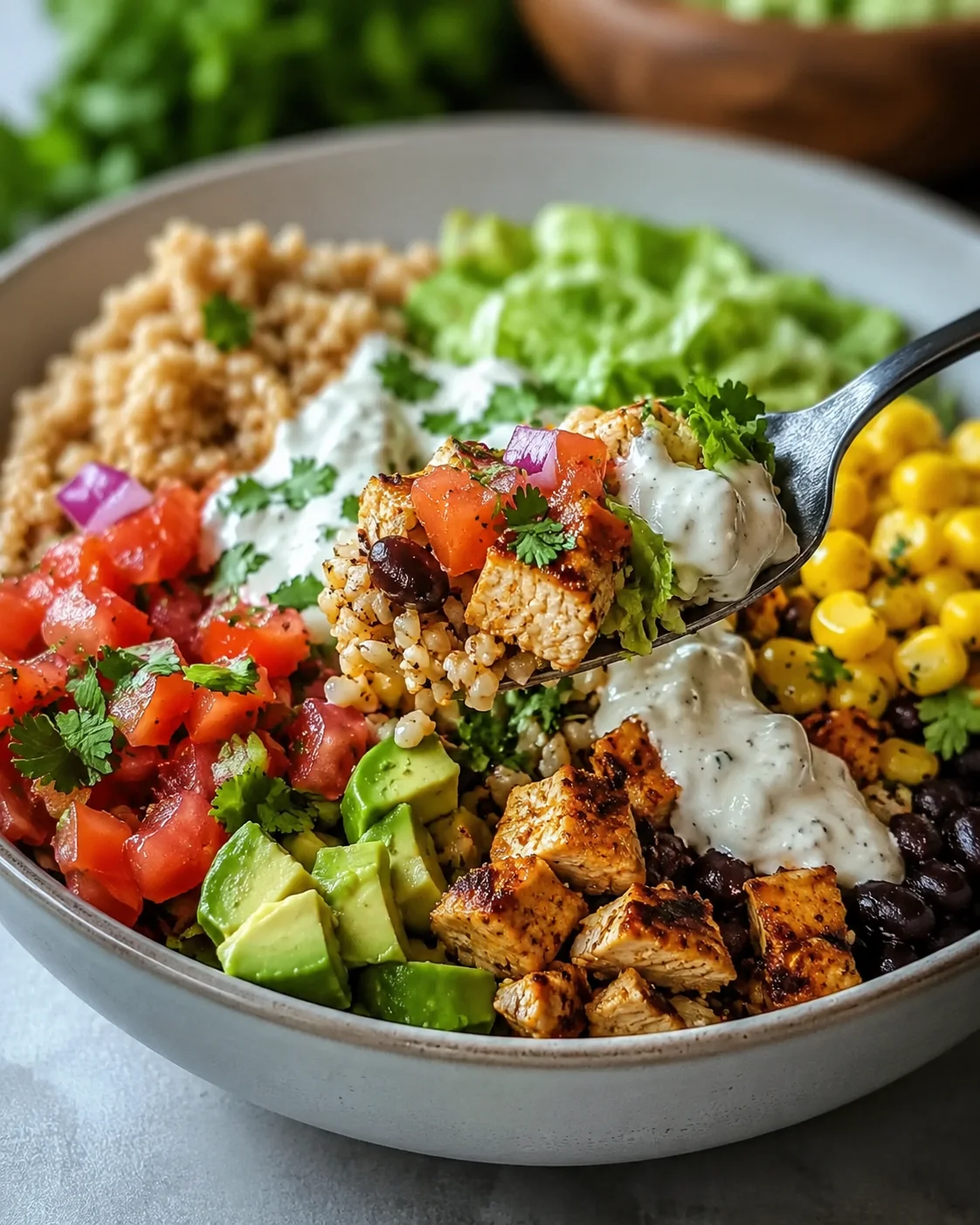A colorful chicken burrito bowl filled with fresh vegetables and protein-rich ingredients.
