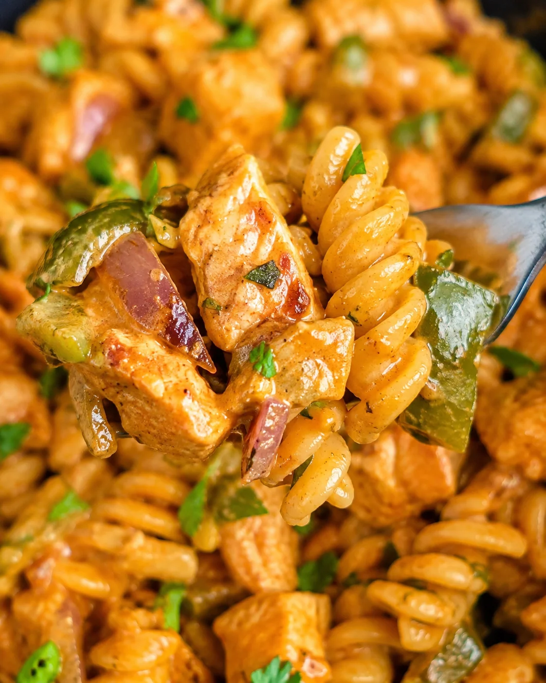 Close-up of creamy, spicy chicken fajita pasta with peppers and cheese