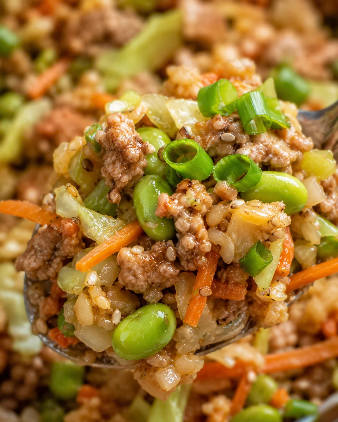 Close-up of colorful veggie-packed turkey egg roll in a bowl with green onions