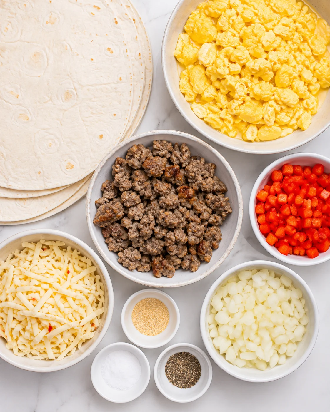 Ingredients for tasty, protein-packed breakfast burritos including eggs, turkey sausage, and cheese.