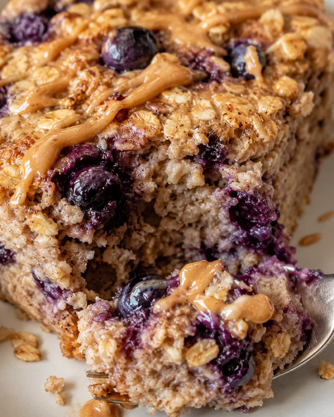 Close-up of blueberry oat coffee cake with crumb topping and caramel drizzle