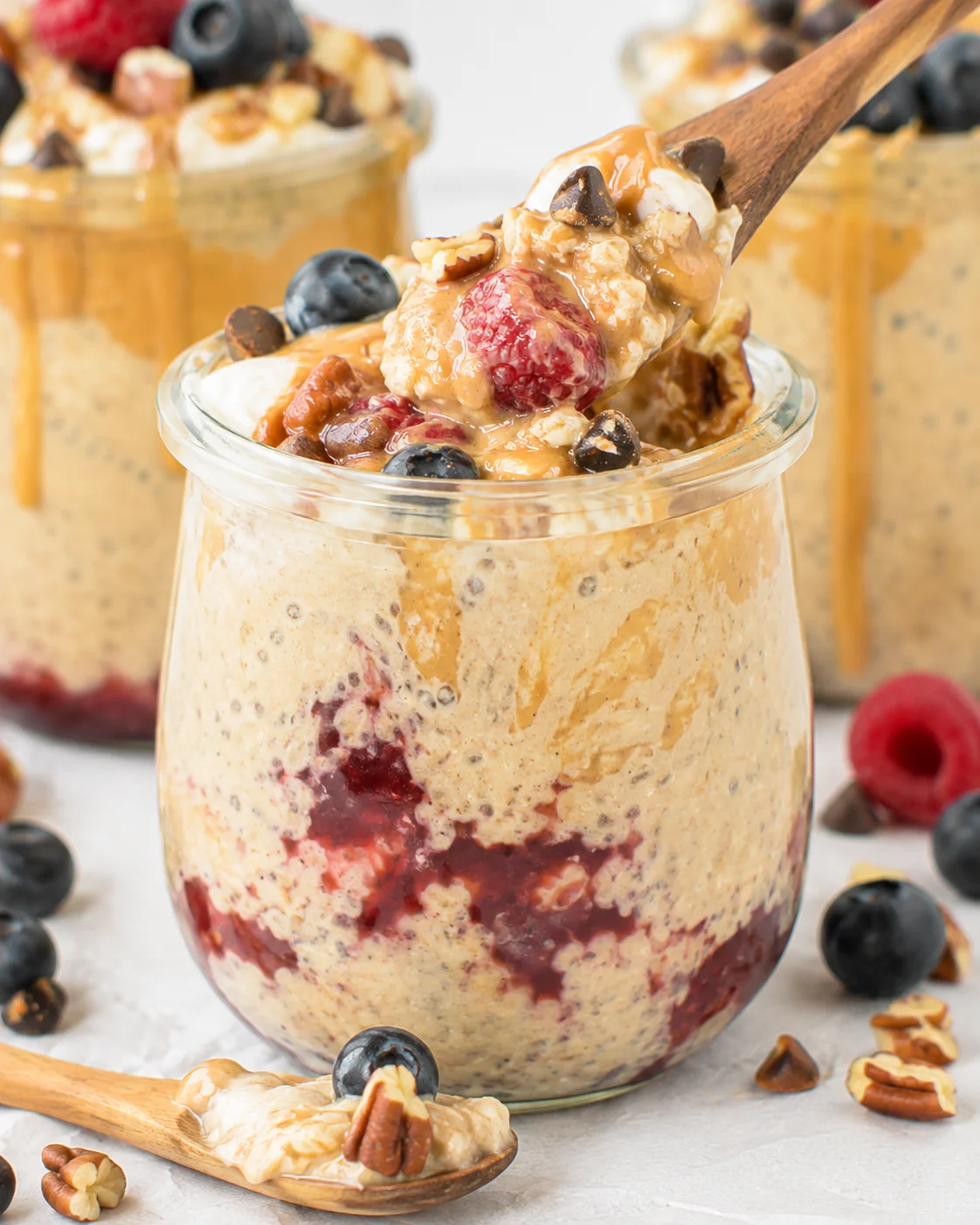 Delicious vegan overnight oats topped with blueberries, raspberries, and nuts
