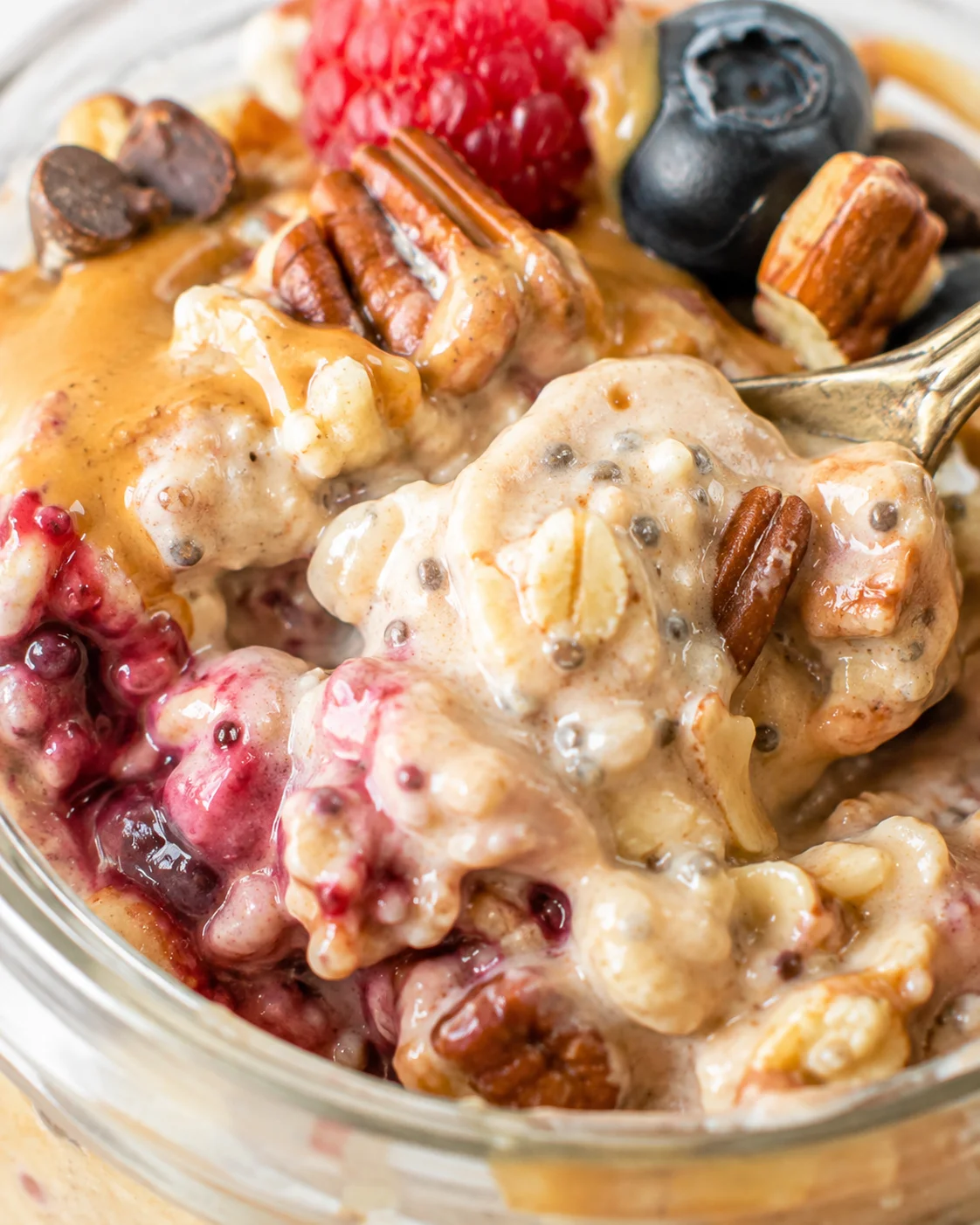 Close-up of creamy overnight oats topped with berries and nuts
