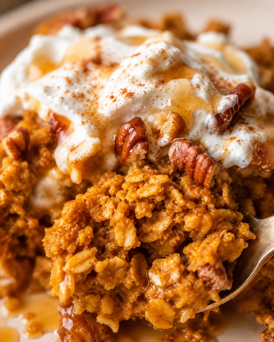 Close-up of the interior texture of pumpkin baked oatmeal with yogurt, pecans, and syrup