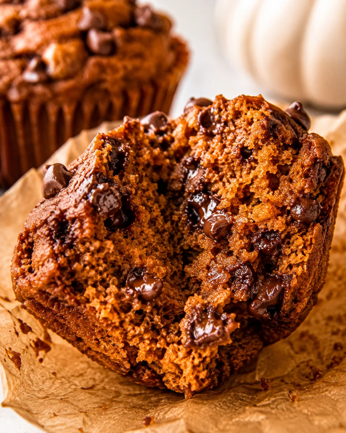 Close-up of the crumb and melted chocolate chips inside a pumpkin protein muffin