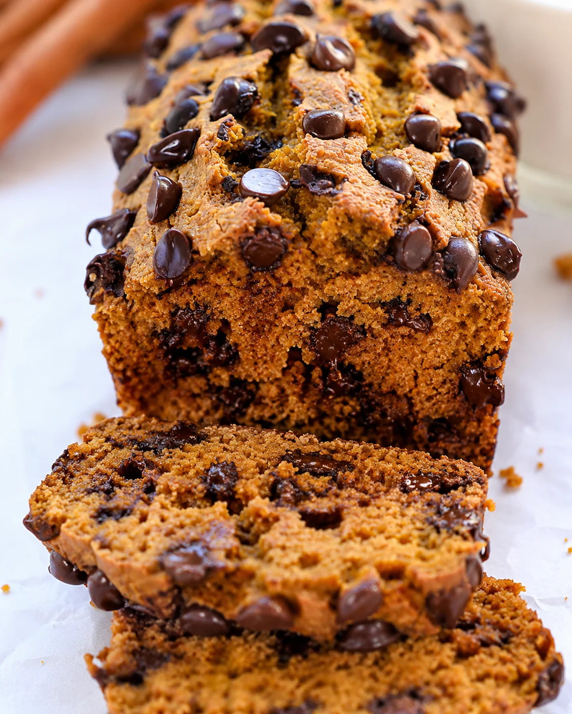 Close-up of sliced protein pumpkin bread showing moist crumb and chocolate chips
